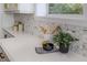Bright kitchen with white quartz countertop, hexagonal backsplash, and stainless steel appliances at 746 Mississippi Ave, Lakeland, FL 33801