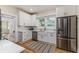 Modern kitchen features white cabinets, stainless steel appliances, and a charming farmhouse sink at 746 Mississippi Ave, Lakeland, FL 33801