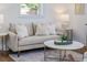 Neutral living room showcases a comfortable sofa, natural light, and a decorative rug at 746 Mississippi Ave, Lakeland, FL 33801