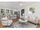 Open-concept living area flows to kitchen and dining; bright with stylish furnishings at 746 Mississippi Ave, Lakeland, FL 33801