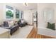 Cozy sunroom with hardwood floors, two plush chairs, and multiple windows at 746 Mississippi Ave, Lakeland, FL 33801