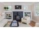 Bright living room features fireplace, built-in bookshelves, neutral decor, and hardwood floors at 746 Mississippi Ave, Lakeland, FL 33801