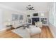 Bright living room features fireplace, built-in bookshelves, neutral decor, and hardwood floors at 746 Mississippi Ave, Lakeland, FL 33801