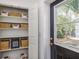 A tidy mudroom features open storage with baskets and a view to the fenced-in backyard at 746 Mississippi Ave, Lakeland, FL 33801