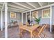 Relaxing outdoor porch space with brick flooring, dining table, and view of fenced yard at 746 Mississippi Ave, Lakeland, FL 33801