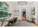 Bright study with a large window, hardwood floors, modern desk, and views of the lush greenery outside at 746 Mississippi Ave, Lakeland, FL 33801