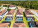 Aerial view of the property with a screened-in pool, surrounded by lush greenery and neighboring houses at 8929 Sugar Palm Rd, Kissimmee, FL 34747
