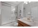 A clean bathroom features a combined bathtub and shower with a glass enclosure at 8929 Sugar Palm Rd, Kissimmee, FL 34747