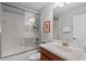 A clean bathroom features a combined bathtub and shower with a glass enclosure at 8929 Sugar Palm Rd, Kissimmee, FL 34747