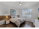 This bedroom features a decorative headboard, ceiling fan and natural light at 8929 Sugar Palm Rd, Kissimmee, FL 34747