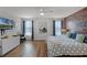 Stylish bedroom features a decorative wood accent wall, ceiling fan, and sleek furniture at 8929 Sugar Palm Rd, Kissimmee, FL 34747
