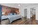 Inviting bedroom with a wood accent wall, stylish furniture, and plenty of natural light at 8929 Sugar Palm Rd, Kissimmee, FL 34747