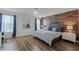 Charming bedroom with wood accent wall, modern decor, and ample natural light at 8929 Sugar Palm Rd, Kissimmee, FL 34747