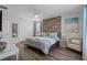 This bedroom features hardwood floors, a king bed, and a decorative wood panel at 8929 Sugar Palm Rd, Kissimmee, FL 34747