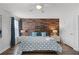 Comfortable bedroom featuring a wood accent wall, ceiling fan and attractive furnishings at 8929 Sugar Palm Rd, Kissimmee, FL 34747