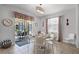 Cozy dining area with a glass-top table, modern chairs, and access to the outdoor patio with a pool view at 8929 Sugar Palm Rd, Kissimmee, FL 34747
