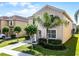 Side view of a well-maintained two-story home with a landscaped yard and driveway, showcasing its charming curb appeal at 8929 Sugar Palm Rd, Kissimmee, FL 34747