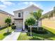 Charming two-story home with a well-manicured front yard and a neutral color scheme at 8929 Sugar Palm Rd, Kissimmee, FL 34747