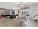 Open-concept living and dining area with modern furnishings, tile flooring, and sliding glass doors to outdoor pool at 8929 Sugar Palm Rd, Kissimmee, FL 34747