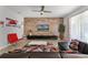 Bright living room featuring wood accent wall, ceiling fan, and modern decor at 8929 Sugar Palm Rd, Kissimmee, FL 34747