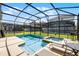 A refreshing pool and hot tub are surrounded by a screened enclosure, perfect for relaxing outdoors at 8929 Sugar Palm Rd, Kissimmee, FL 34747