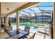 Enjoy the backyard pool and spa from the covered patio at 8929 Sugar Palm Rd, Kissimmee, FL 34747