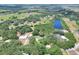 A home nestled among mature trees near a pond and green pastures in a quiet neighborhood at 930 Country Oaks Ln, Lakeland, FL 33810