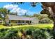 Beautiful backyard featuring mature trees, lush landscaping, and well-maintained lawn at 930 Country Oaks Ln, Lakeland, FL 33810