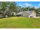 Spacious backyard with plenty of green space and mature trees at 930 Country Oaks Ln, Lakeland, FL 33810