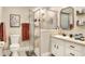 Bathroom featuring a glass shower, toilet, and a vanity with a sink and framed mirror at 930 Country Oaks Ln, Lakeland, FL 33810