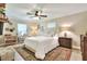 Bedroom featuring a ceiling fan, white rug, desk, and natural light from the windows at 930 Country Oaks Ln, Lakeland, FL 33810