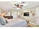 Bedroom featuring a queen bed, ceiling fan, TV, and closet at 930 Country Oaks Ln, Lakeland, FL 33810