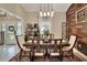 Dining room featuring wood table and chairs, with a rustic accent wall at 930 Country Oaks Ln, Lakeland, FL 33810