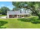 Charming exterior elevation of the home featuring a brick facade and covered front porch at 930 Country Oaks Ln, Lakeland, FL 33810
