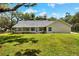 Wide view of the exterior, including the backyard and screened in back porch at 930 Country Oaks Ln, Lakeland, FL 33810