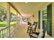Relaxing front porch with rocking chairs and a view of the spacious front yard at 930 Country Oaks Ln, Lakeland, FL 33810