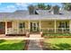 Inviting front porch with white railings, swing, and charming details at 930 Country Oaks Ln, Lakeland, FL 33810