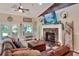 Inviting living room with fireplace, TV, and leather sofa at 930 Country Oaks Ln, Lakeland, FL 33810