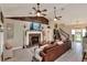 Open-concept living room with stone fireplace and ample seating at 930 Country Oaks Ln, Lakeland, FL 33810