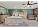 Spacious main bedroom features a ceiling fan, tile floors, a wooden accent wall, and an attached crib at 930 Country Oaks Ln, Lakeland, FL 33810