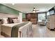 Spacious main bedroom with wood floors, en-suite bath, and rustic accent wall at 930 Country Oaks Ln, Lakeland, FL 33810