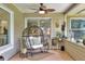 Relaxing porch with a hanging chair, tile flooring, and a ceiling fan at 930 Country Oaks Ln, Lakeland, FL 33810