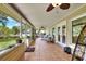 Large screened porch with tile flooring, multiple ceiling fans, and access to the backyard at 930 Country Oaks Ln, Lakeland, FL 33810