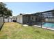 Backyard featuring a screened-in pool and a partially fenced-in yard at 108 Sandburg Ln, Winter Haven, FL 33884