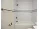 Bathroom featuring white subway tile in the shower and neutral-toned accent tiles at 108 Sandburg Ln, Winter Haven, FL 33884