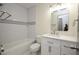 Bathroom featuring white subway tile in the shower, a vanity and a framed mirror at 108 Sandburg Ln, Winter Haven, FL 33884