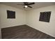 This bedroom features wood-look flooring, a ceiling fan, and dark curtains for privacy and comfort at 108 Sandburg Ln, Winter Haven, FL 33884