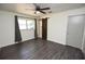 The bedroom features wood-look flooring and neutral decor, enhancing the natural light from the large window at 108 Sandburg Ln, Winter Haven, FL 33884