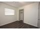 Bright bedroom featuring wood-look flooring, a closet, and a large window allowing for natural light at 108 Sandburg Ln, Winter Haven, FL 33884