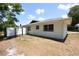 Exterior view of the home showing the side yard with a modern privacy fence at 108 Sandburg Ln, Winter Haven, FL 33884